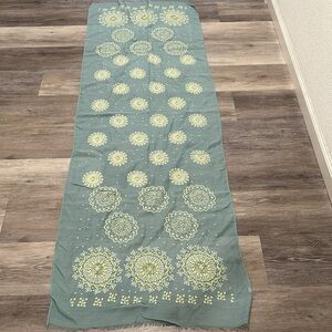 Green scarf with yellow pattern.